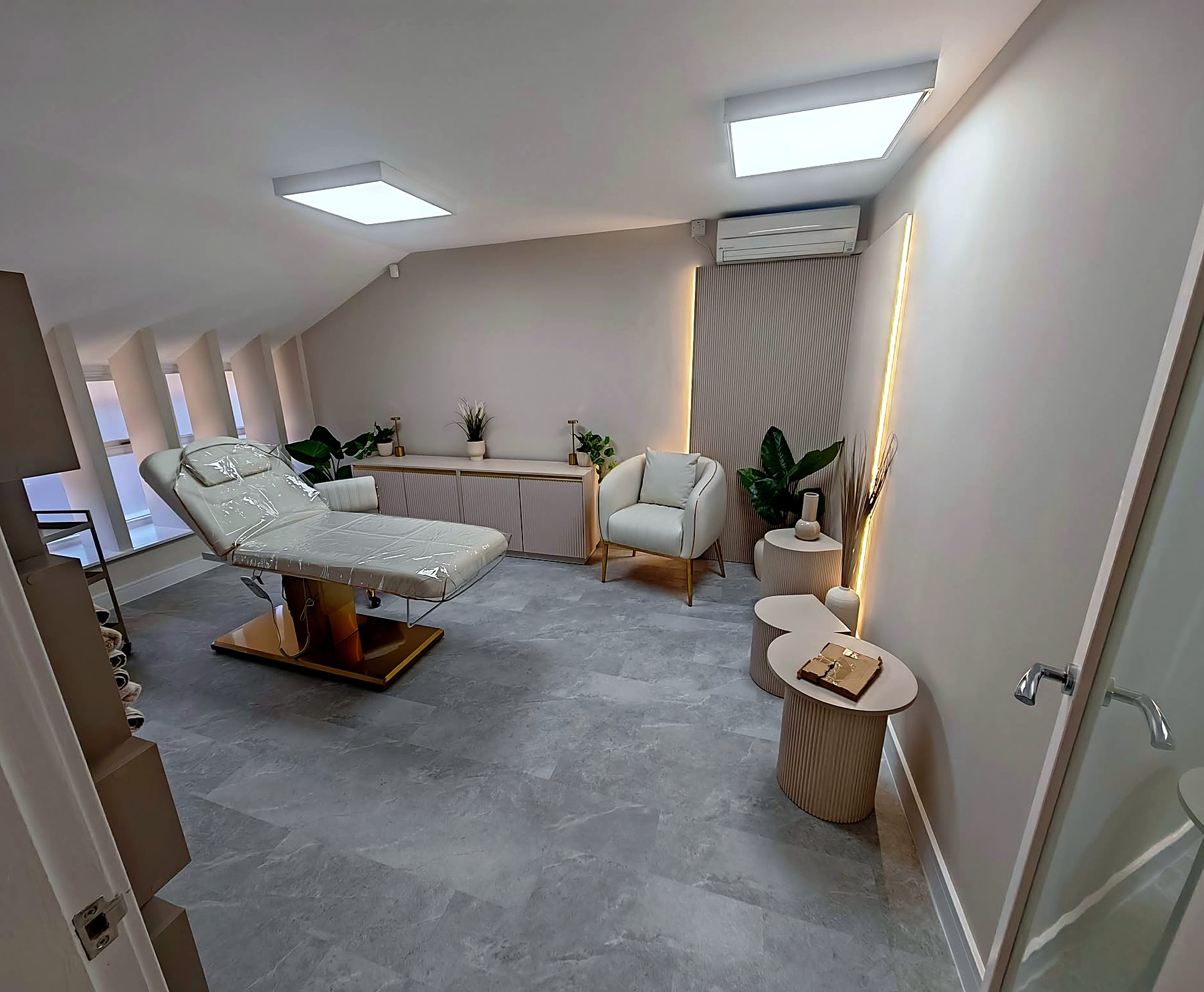 Beauty treatment room with panelled wall, LED strip lighting and air conditioning